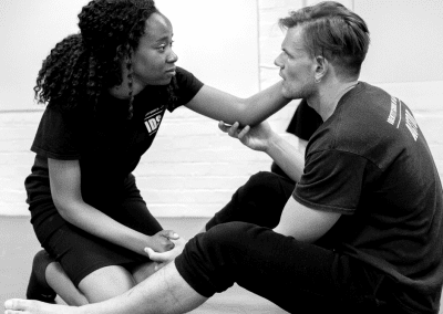 Man and woman sat on the floor having an intimate conversation