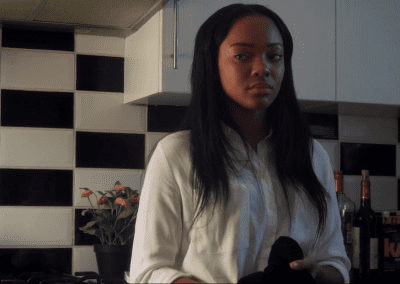 Woman standing in a dark kitchen